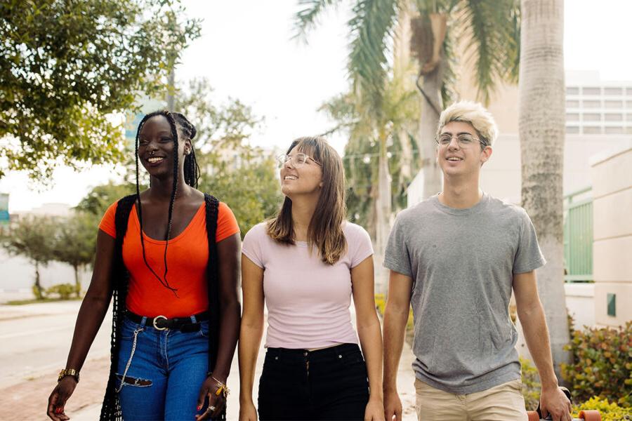 three PBA students program walk together on campus